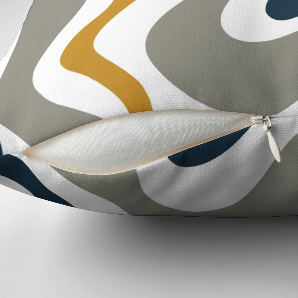 Contemporary abstract patterned pillow in mustard yellow, navy blue, and grey tones.