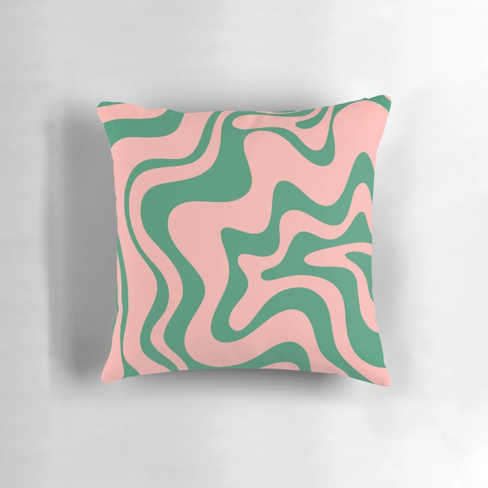 A contemporary abstract pattern pillow in shades of pink and green, with a psychedelic, kaleidoscopic design.