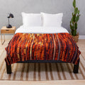 Contemporary abstract striped plush blanket with bold orange, yellow, and red colors