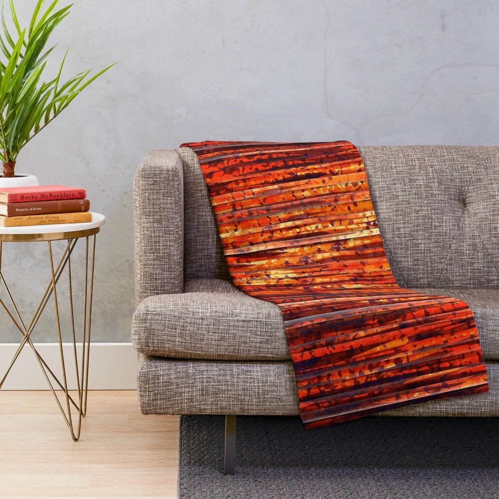 Contemporary abstract striped plush blanket with bold orange, yellow, and red colors