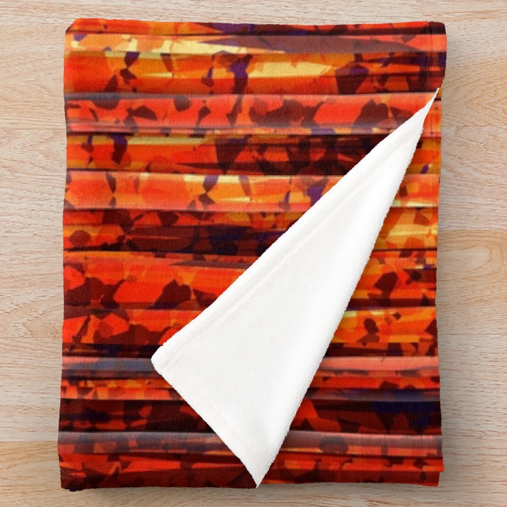 Contemporary abstract striped plush blanket with bold orange, yellow, and red colors