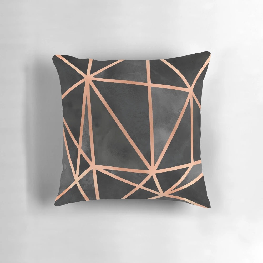 Black and copper geometric throw pillow with a modern, minimalist design