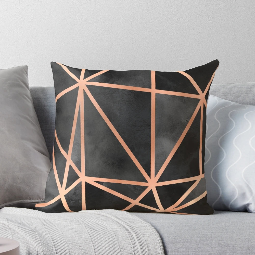 Black and copper geometric throw pillow with a modern, minimalist design