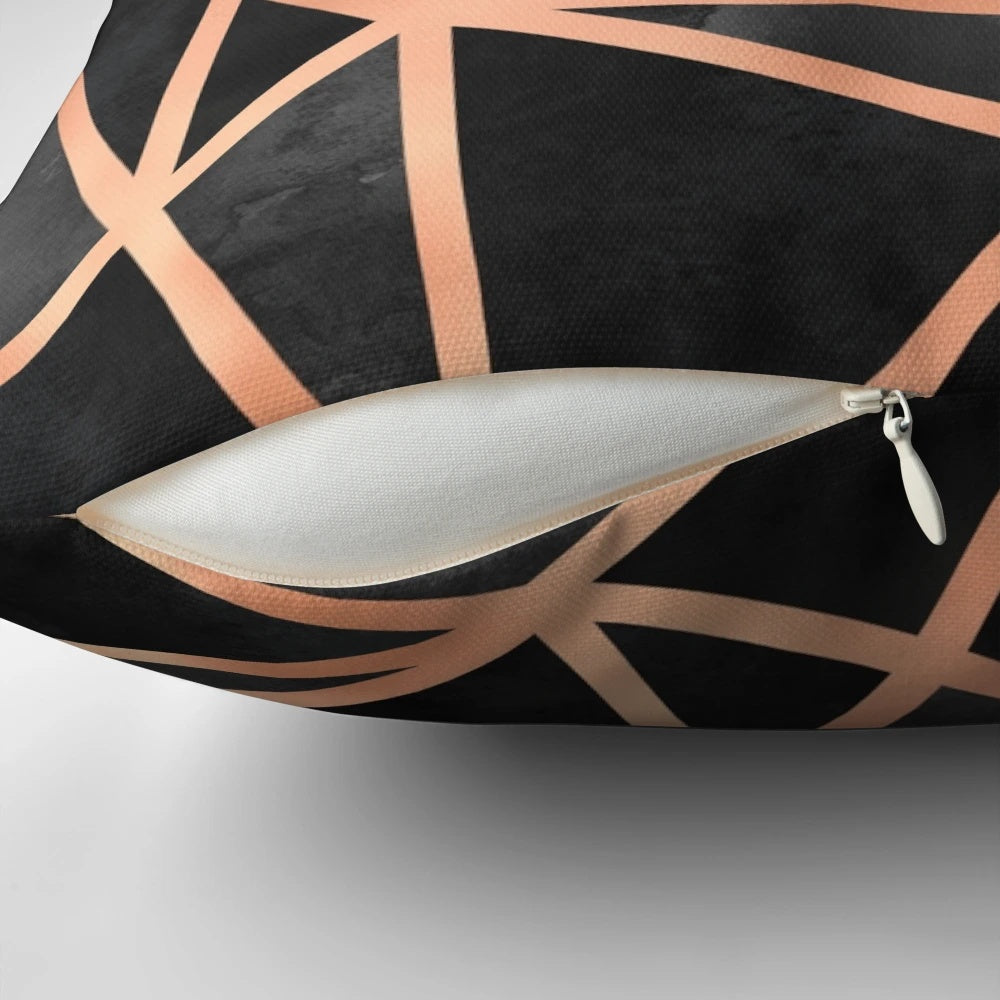 Black and copper geometric throw pillow with a modern, minimalist design