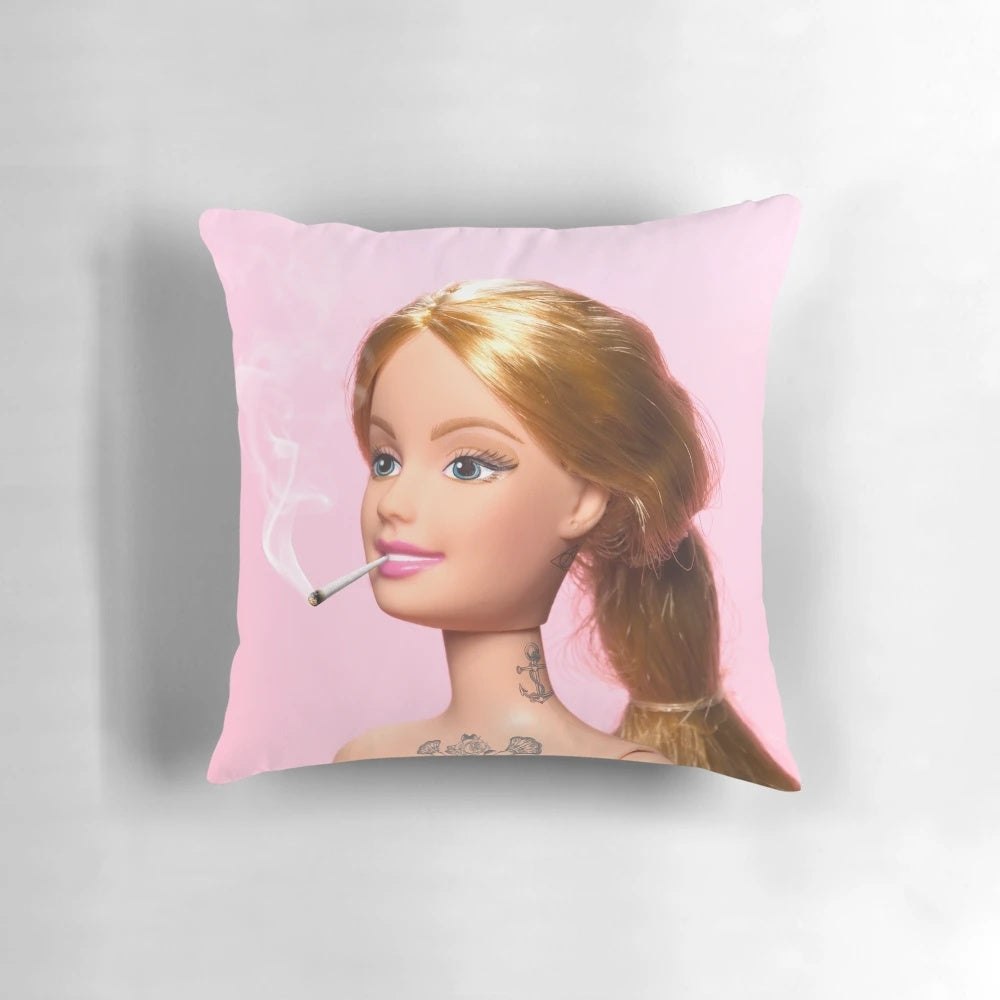 A decorative pillow featuring a surreal, minimalist illustration of a grown-up doll with tattoos and smoke