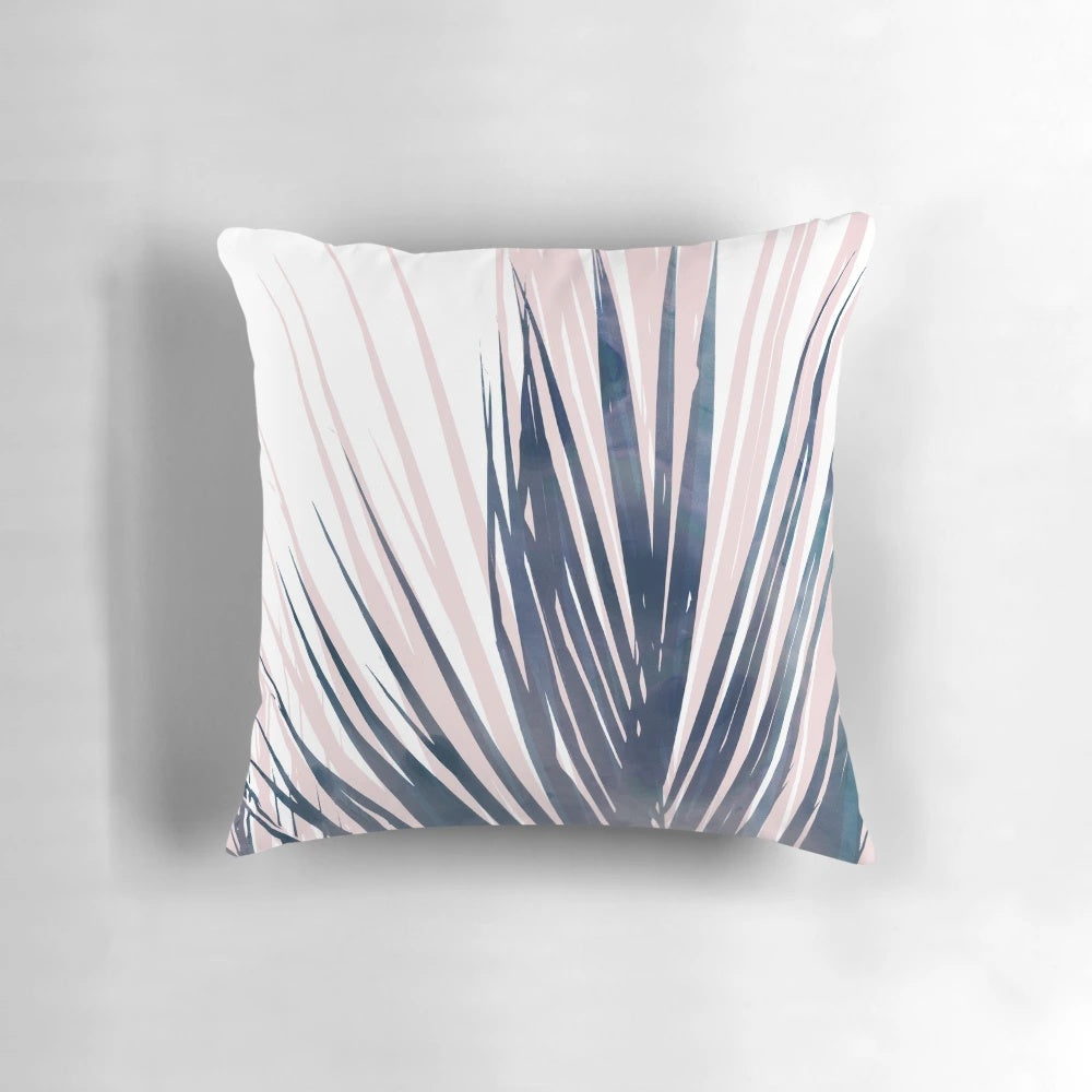 Contemporary palm leaf design pillow in navy blue and blush pink colors