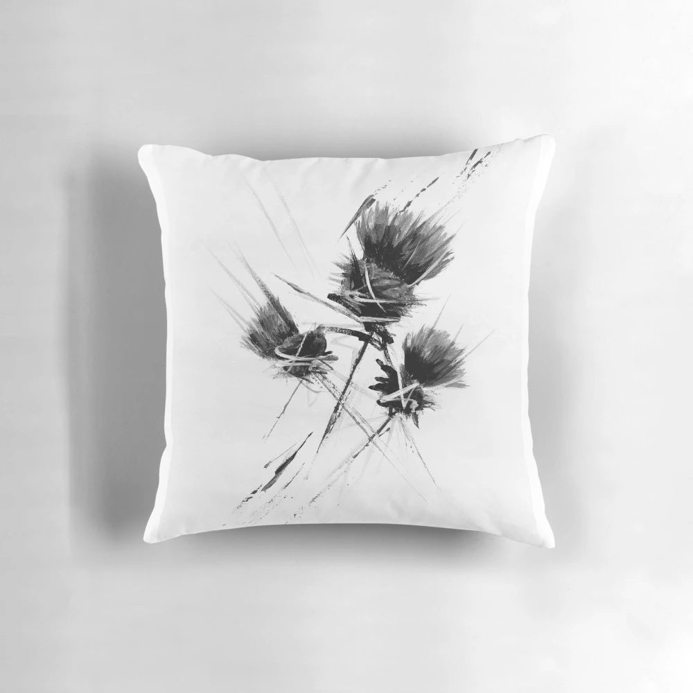 A contemporary black and white pillow featuring a stylized Scottish thistle design, creating a modern and minimalist look.
