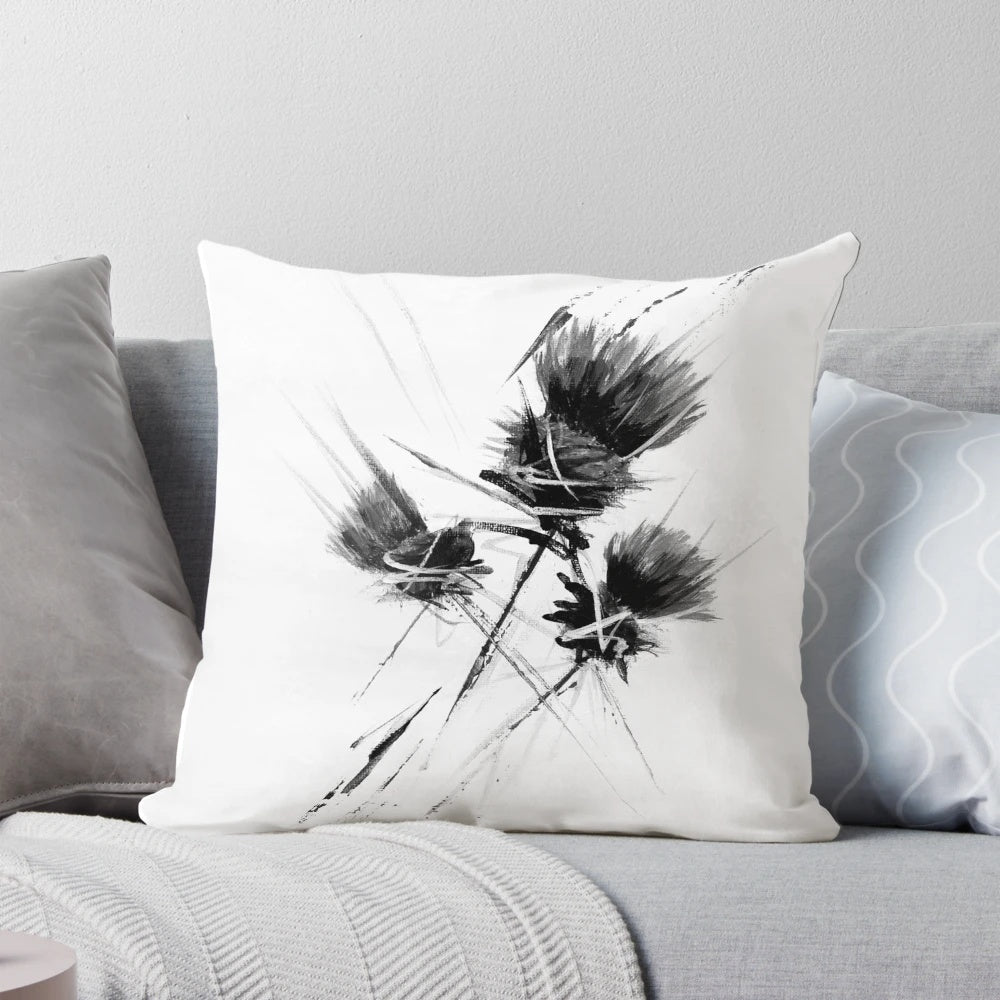 A contemporary black and white pillow featuring a stylized Scottish thistle design, creating a modern and minimalist look.