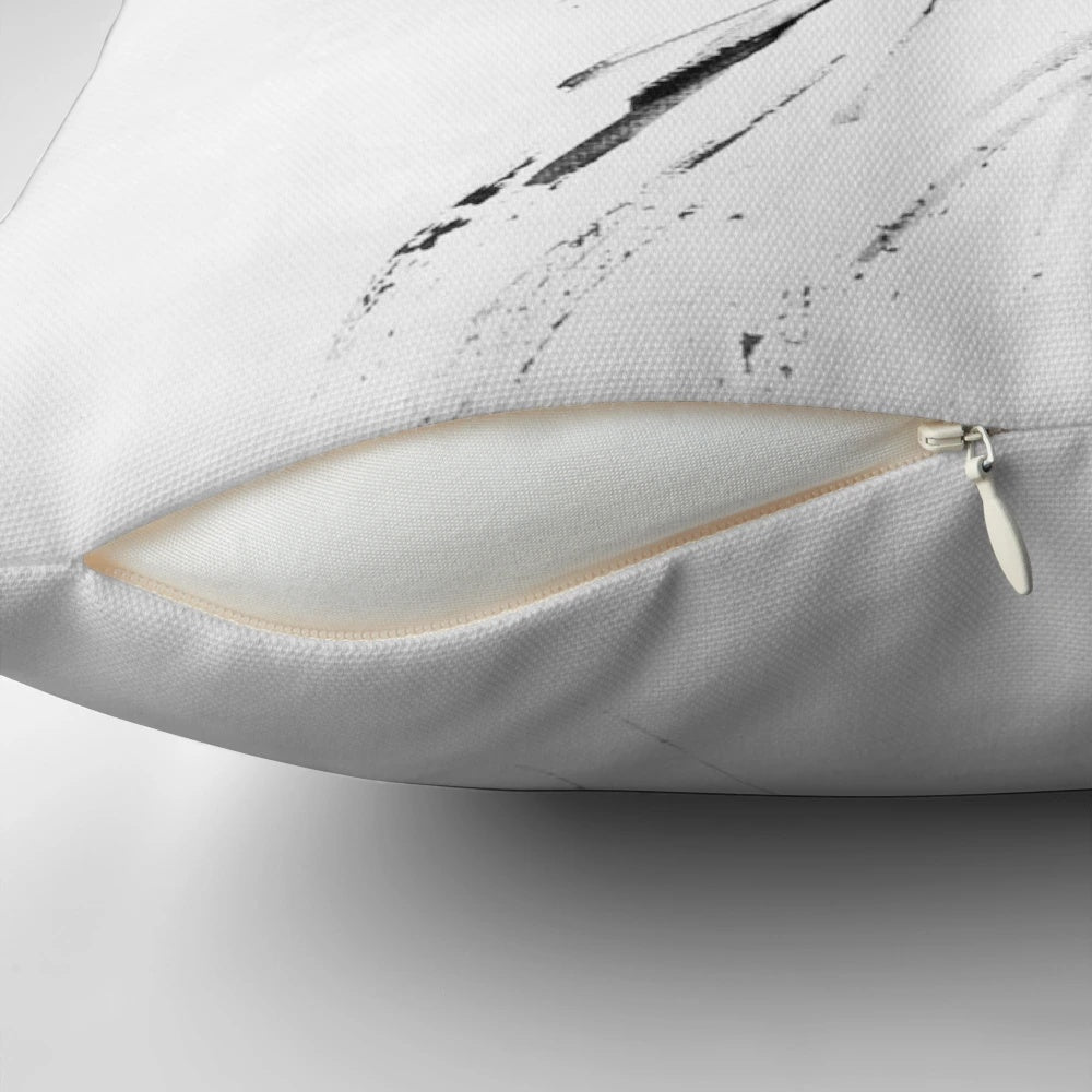 A contemporary black and white pillow featuring a stylized Scottish thistle design, creating a modern and minimalist look.