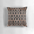 Copper and black pillow with a geometric diamond pattern