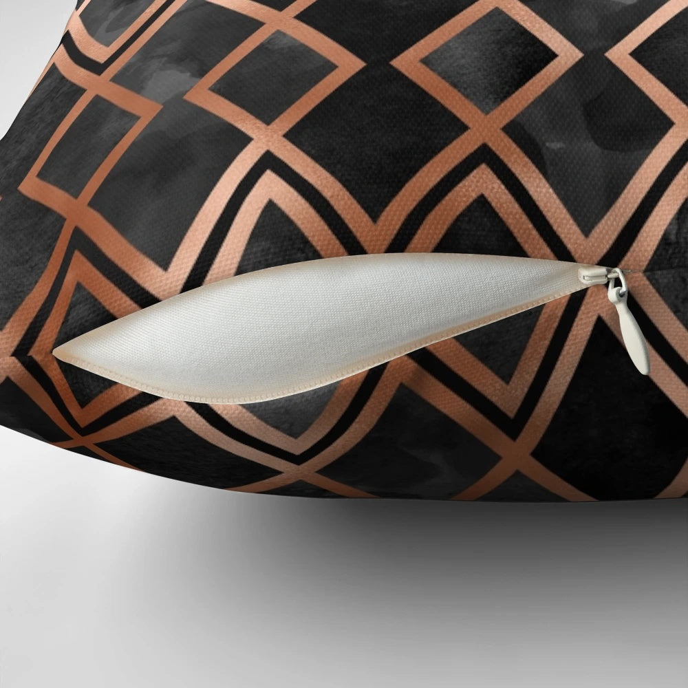 Copper and black pillow with a geometric diamond pattern