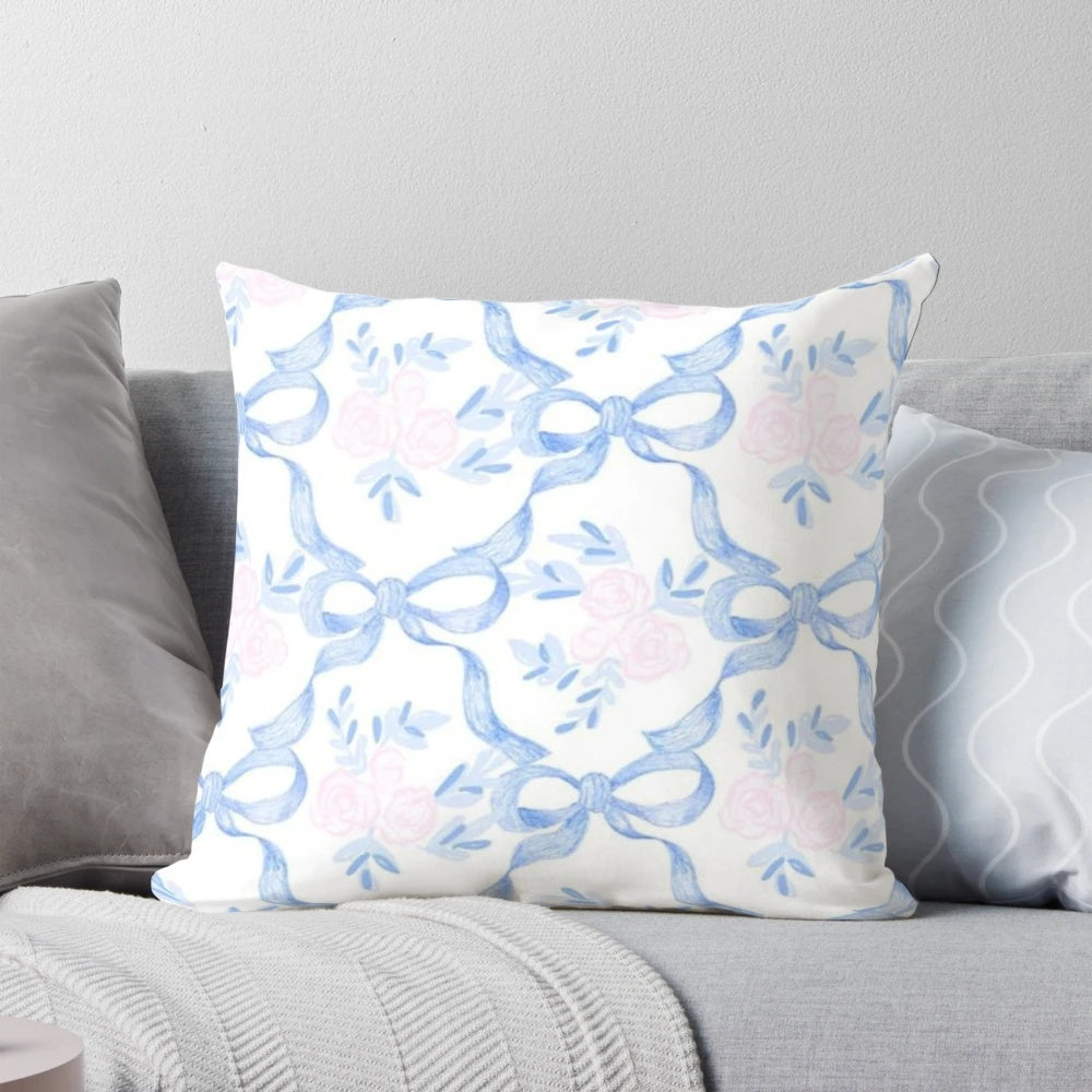 A pink and white pillow with a coquette balletcore pattern, featuring bows and ribbons for a soft, feminine touch.