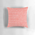 Coral herringbone patterned knit throw pillow with textured design