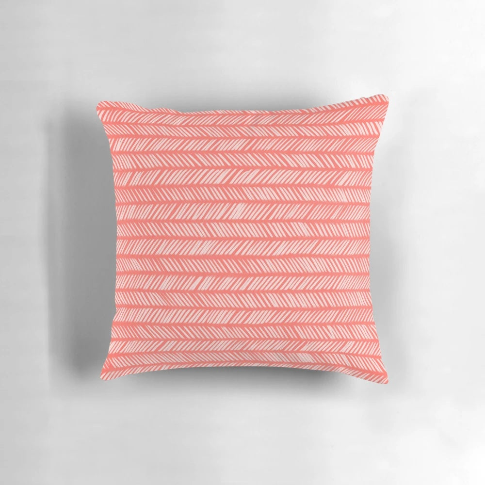 Coral herringbone patterned knit throw pillow with textured design