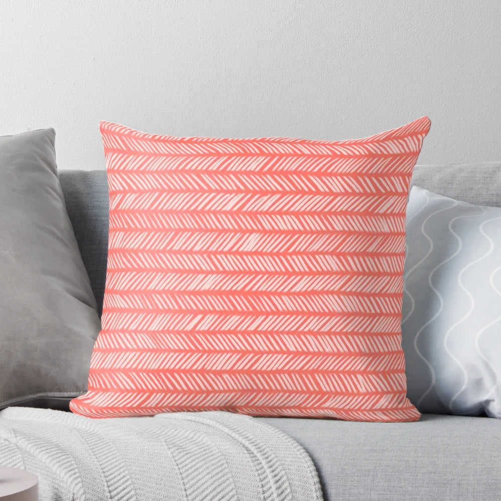 Coral herringbone patterned knit throw pillow with textured design