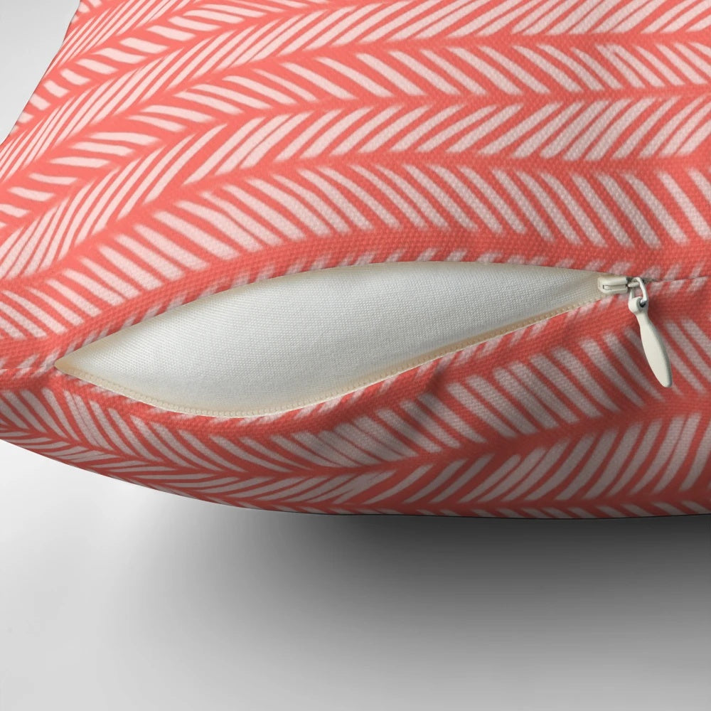 Coral herringbone patterned knit throw pillow with textured design