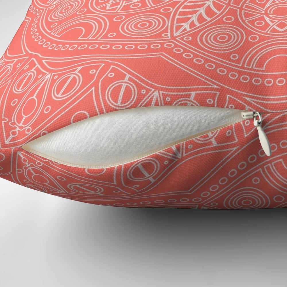Coral and leaf mandala pattern printed on a plush, decorative pillow