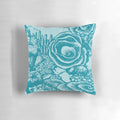 Green and blue colored pillow with a coral reef and ocean life design