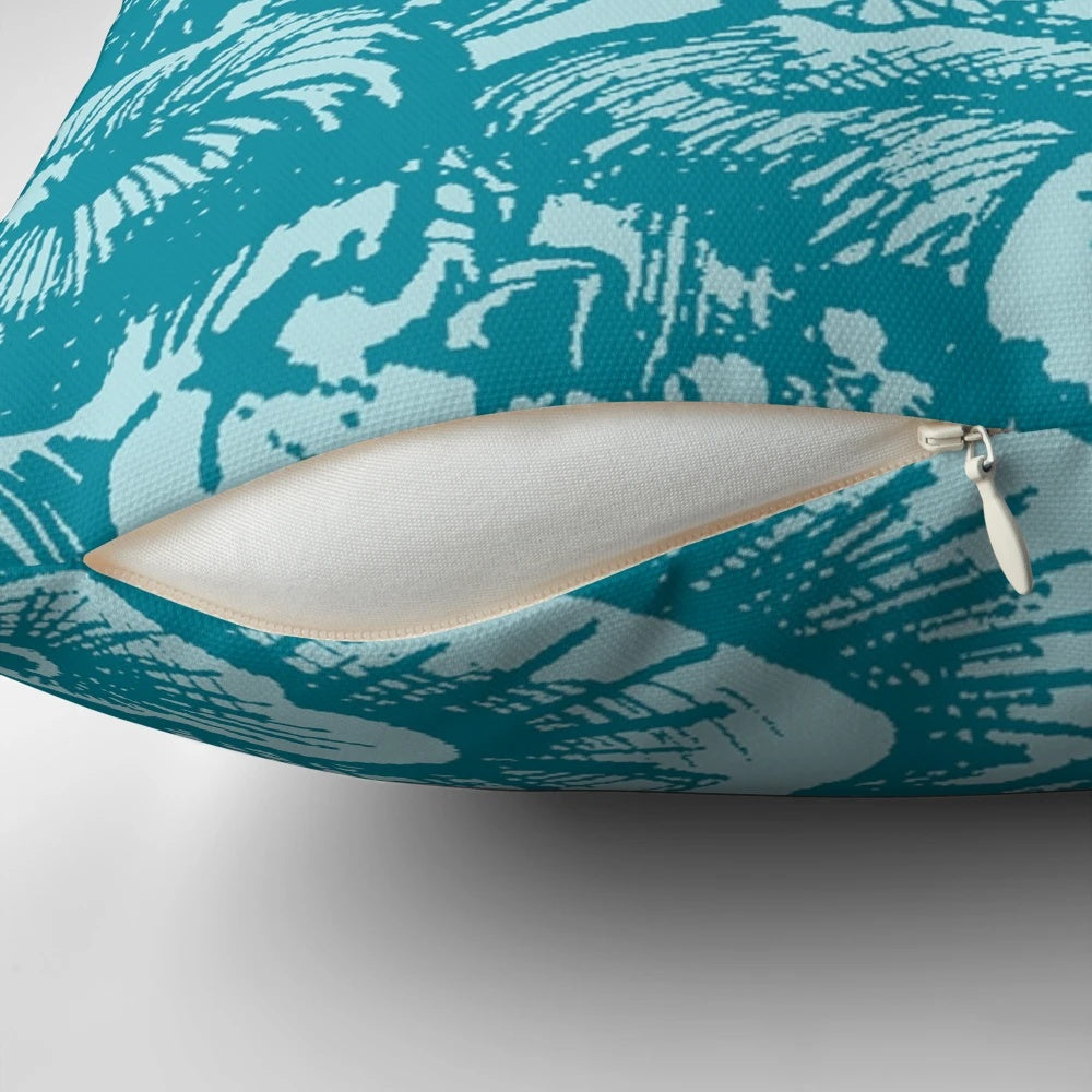 Green and blue colored pillow with a coral reef and ocean life design