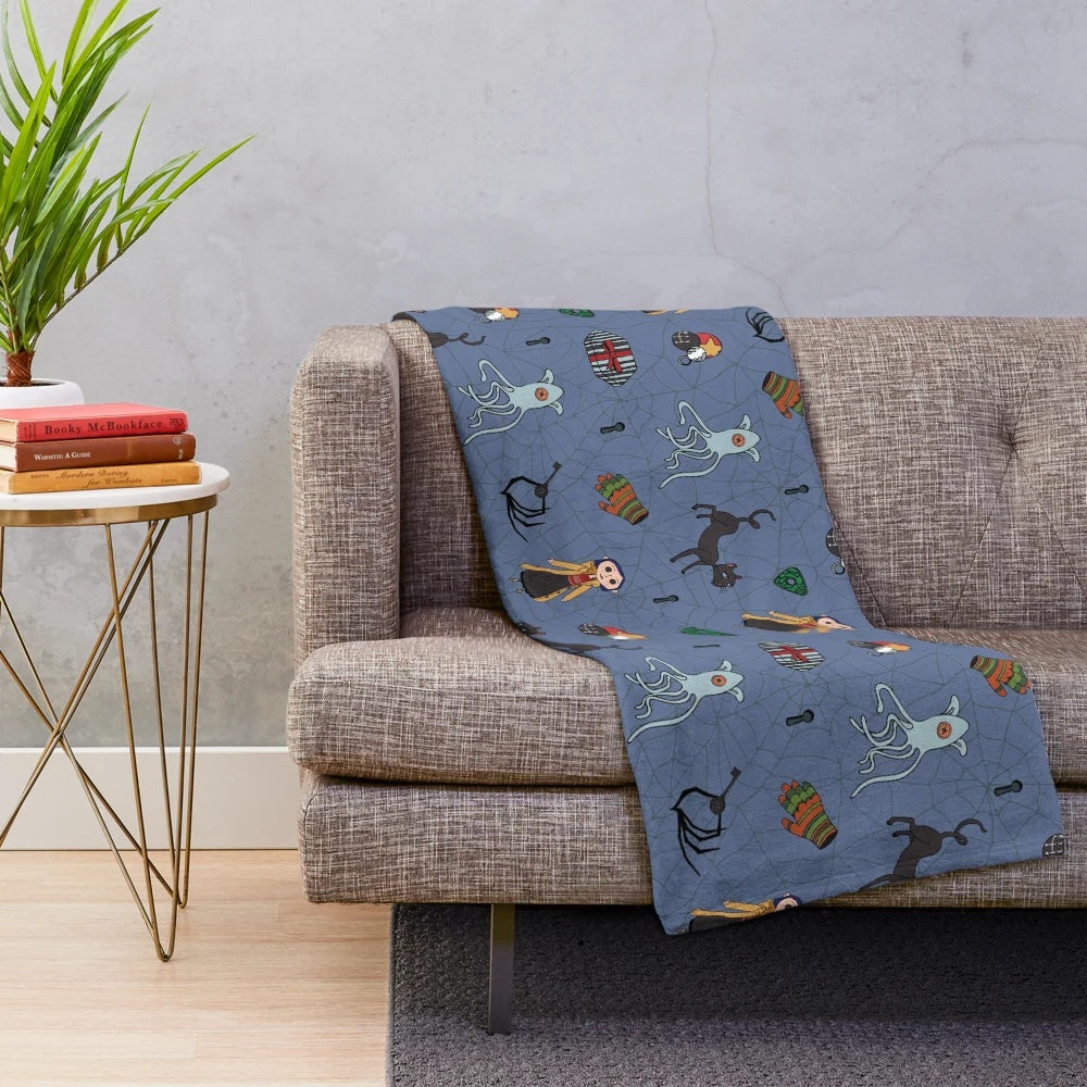 Blue plush blanket with Coraline-inspired pattern