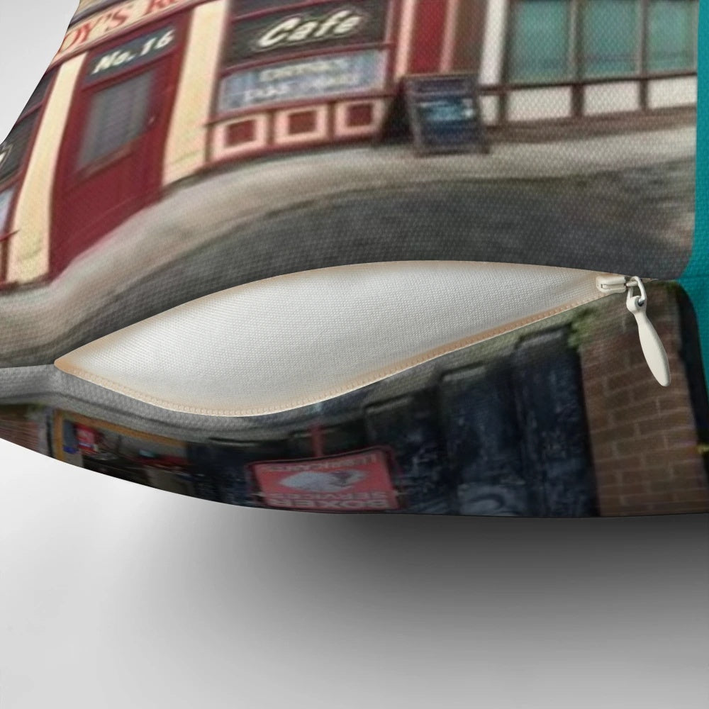 Coronation Street inspired pillow featuring Rovers Return, Roy's Rolls, The Kabin, and other iconic Coronation Street buildings