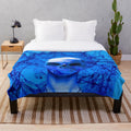 Alien skull plush blanket in vibrant blue and purple hues