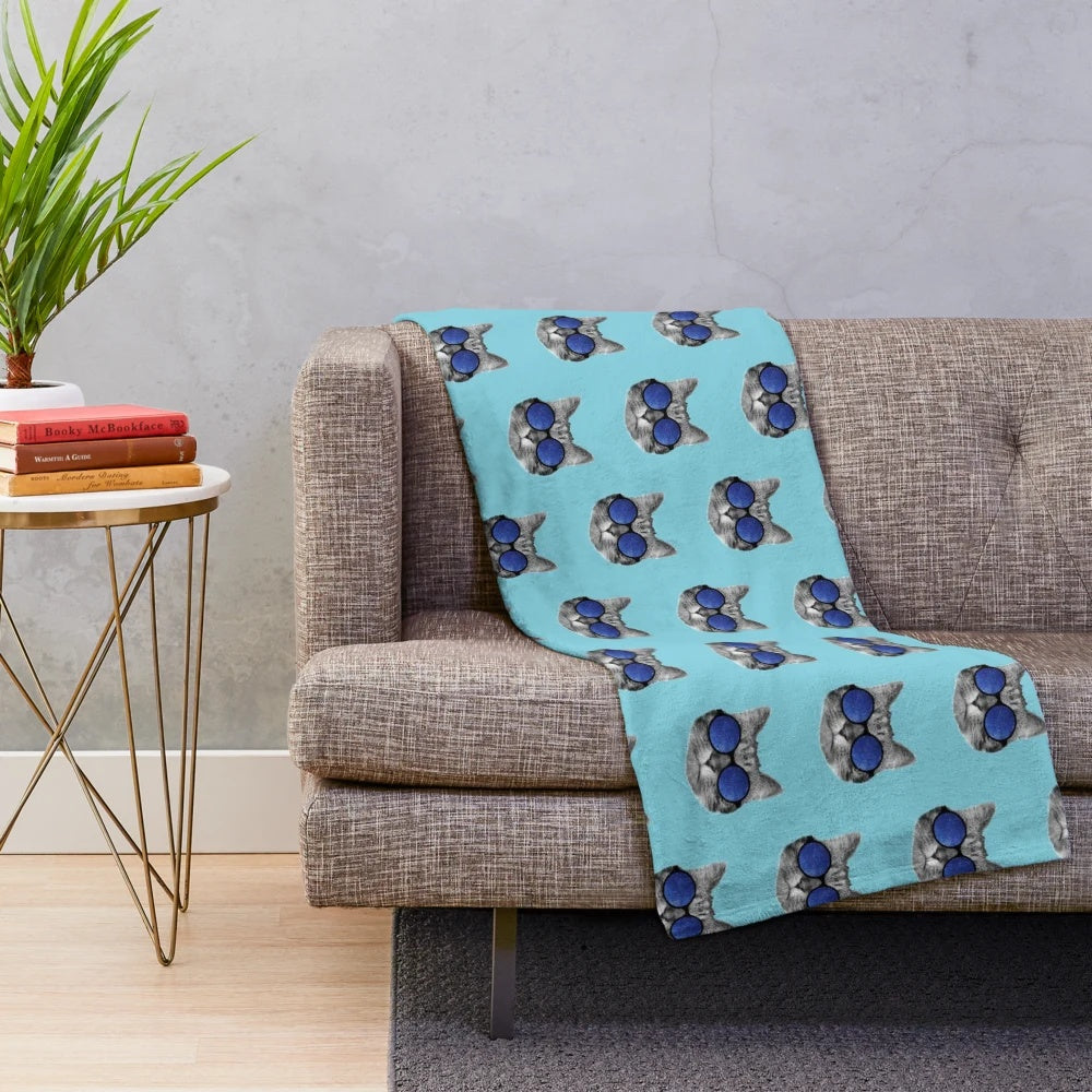 Cute space cat wearing sunglasses on a colorful galaxy plush blanket