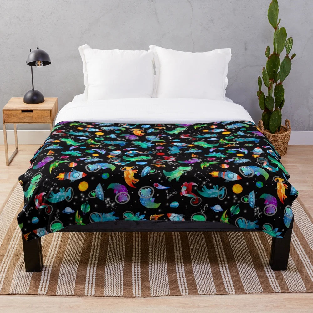 Watercolor dinosaur pattern on a plush galaxy-themed blanket