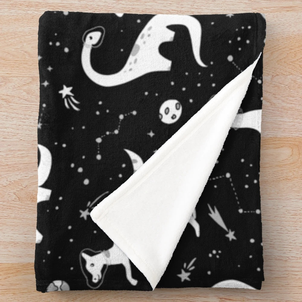 Space Dinosaurs Plush Blanket featuring a galaxy, planets, and cosmic elements