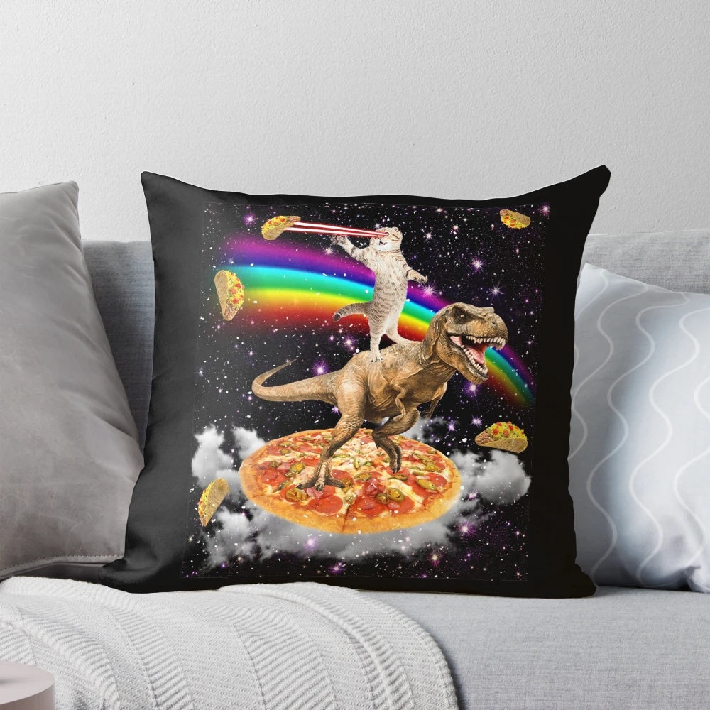 A colorful pillow featuring a galaxy-themed cat on a dinosaur on a pizza, with a rainbow and cosmic elements.