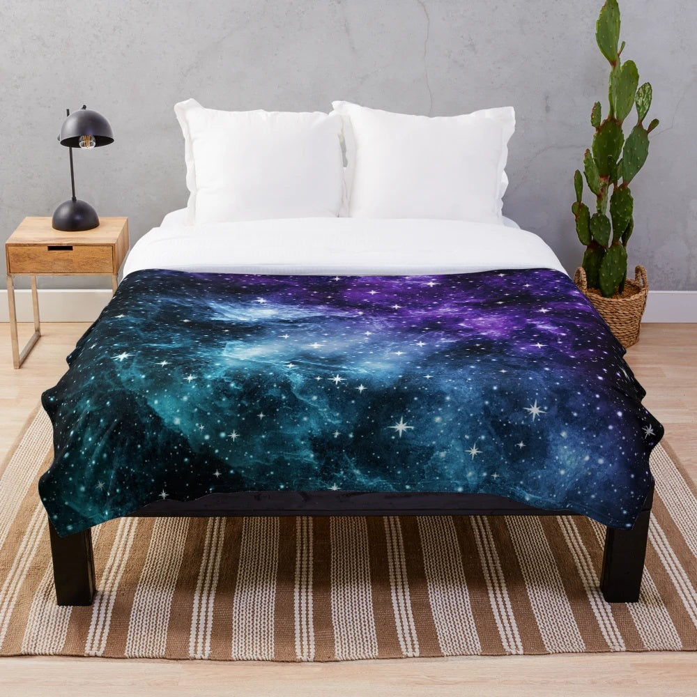 Purple and teal galaxy nebula plush blanket with stars and cosmic design