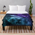 Purple and teal galaxy nebula plush blanket with stars and cosmic design