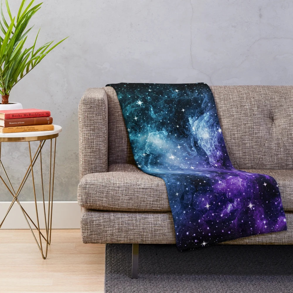 Purple and teal galaxy nebula plush blanket with stars and cosmic design