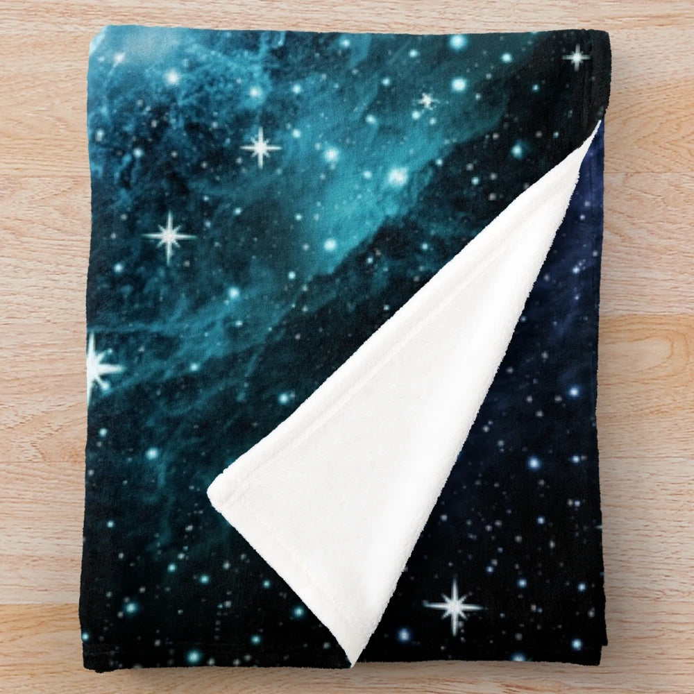 Purple and teal galaxy nebula plush blanket with stars and cosmic design