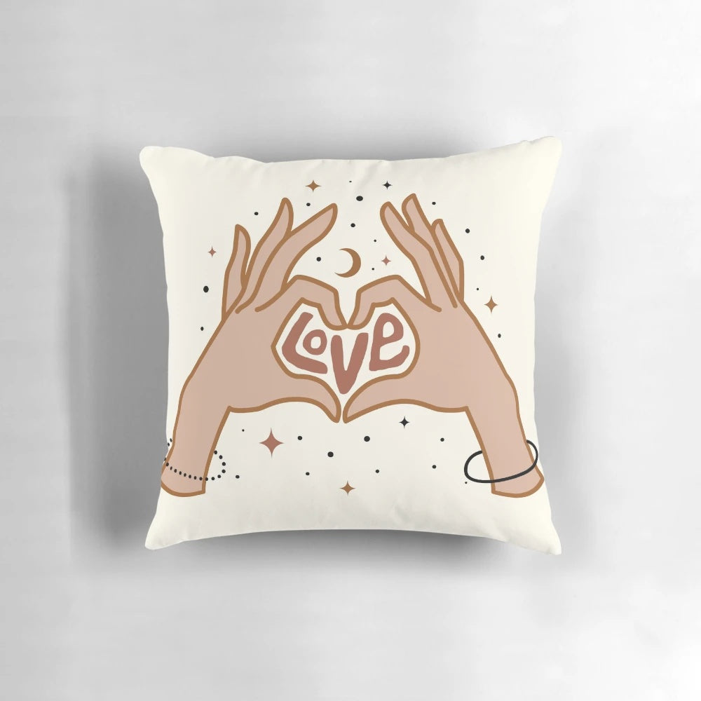 Cosmic-themed pillow with a hand-drawn design of hands forming a love symbol against a starry, galaxy-inspired background.