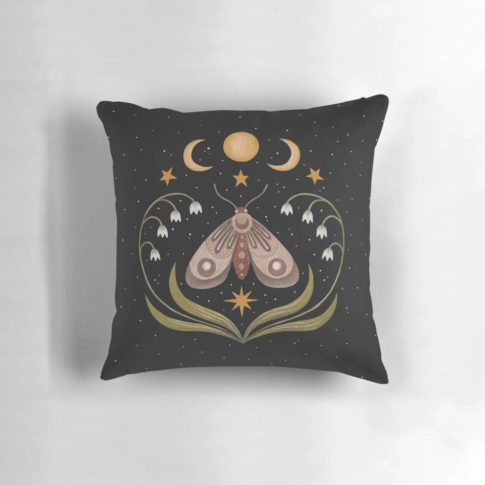 A Pillow with a beautiful night sky design featuring a moth, butterflies, and flowers under three moons
