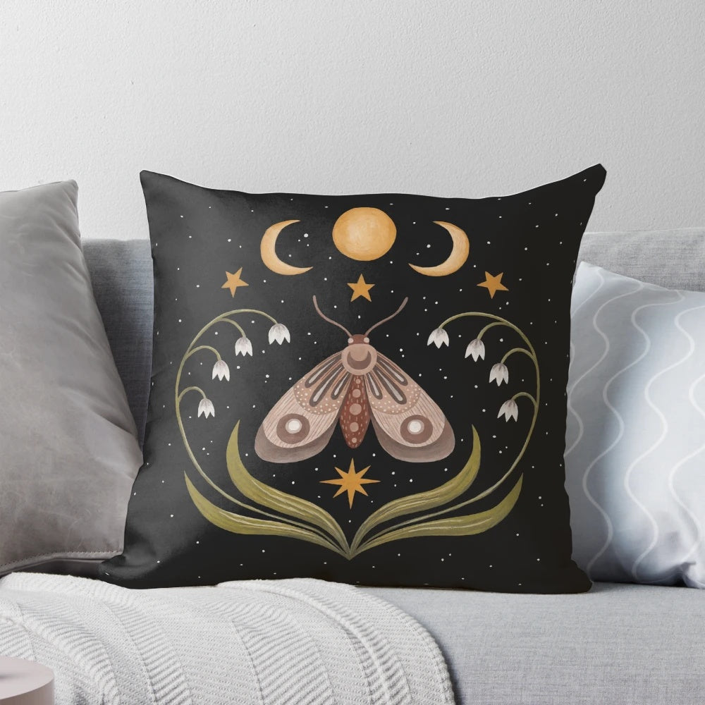 A Pillow with a beautiful night sky design featuring a moth, butterflies, and flowers under three moons