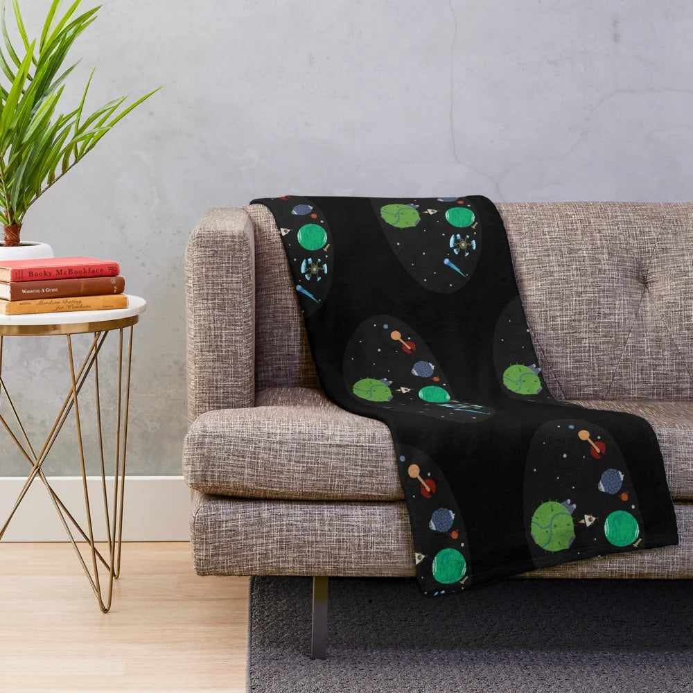 Outer Wilds-themed plush blanket featuring the game's logo and cosmic design