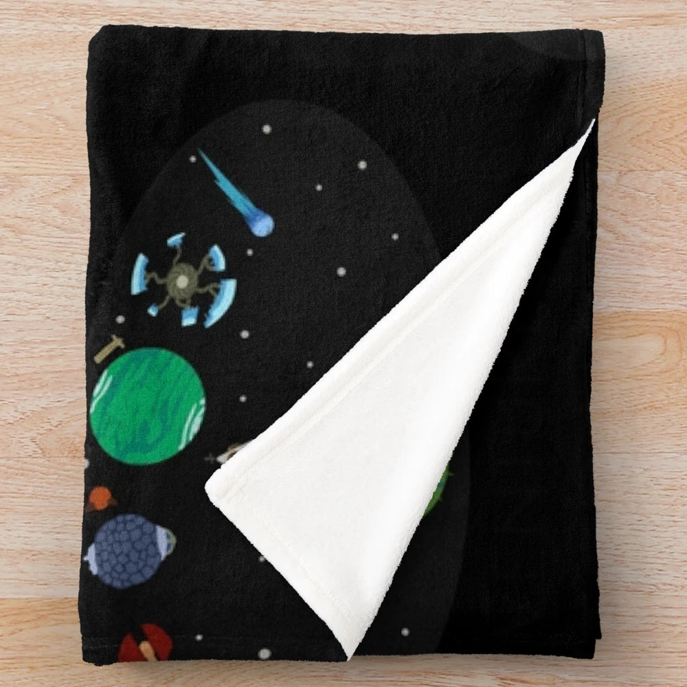 Outer Wilds-themed plush blanket featuring the game's logo and cosmic design