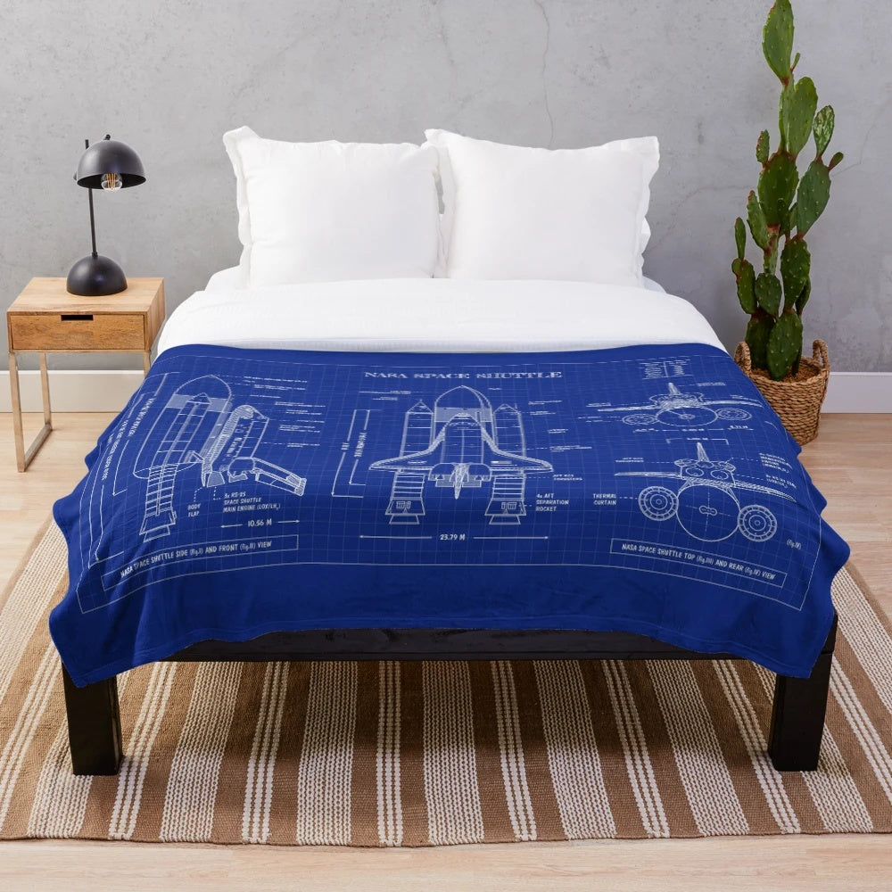 Plush blanket featuring a blueprint-style design of a NASA space shuttle