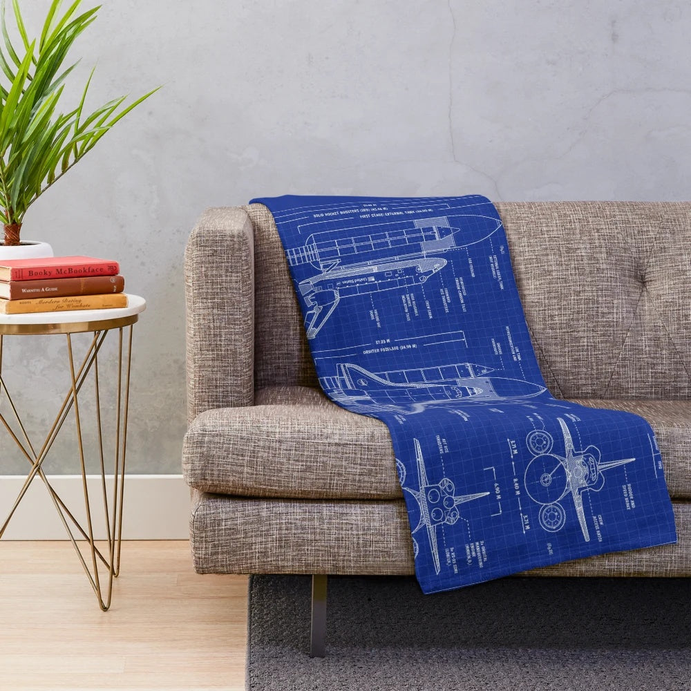 Plush blanket featuring a blueprint-style design of a NASA space shuttle