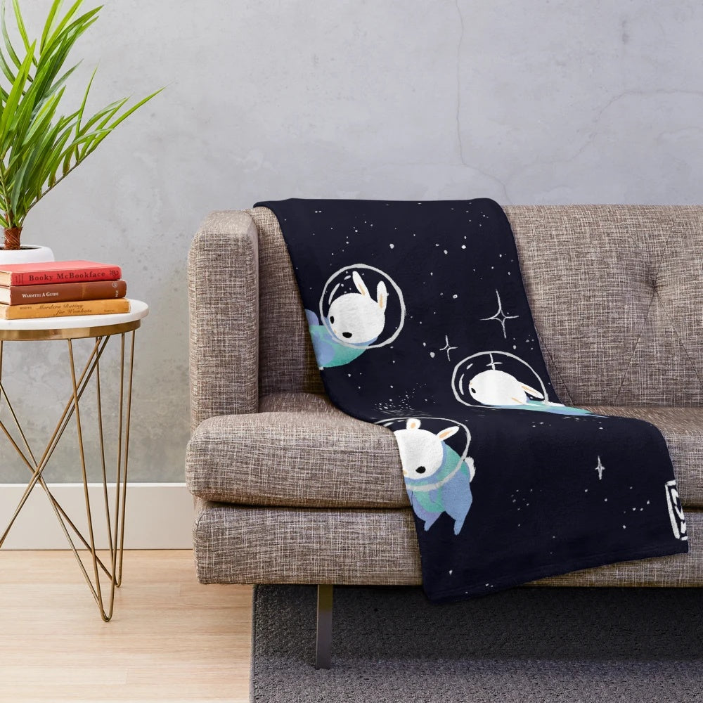 Colorful digital illustration of cute space bunnies on a plush blanket