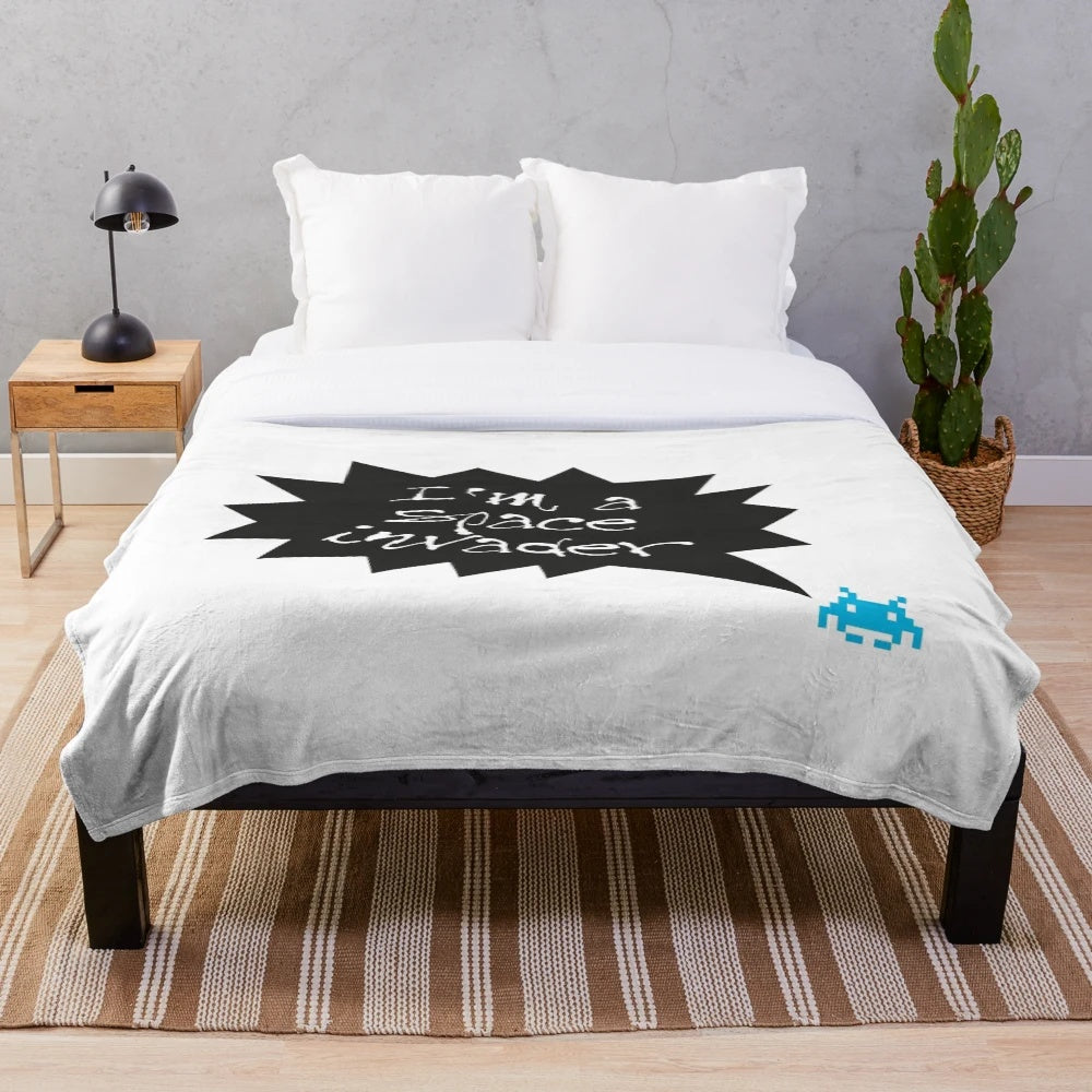 Plush blanket depicting a space invader design, perfect for music fans