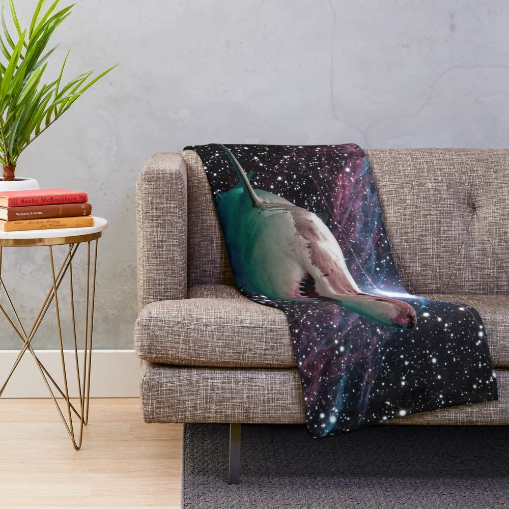 Plush blanket featuring a space shark with glowing teeth and stars in the background