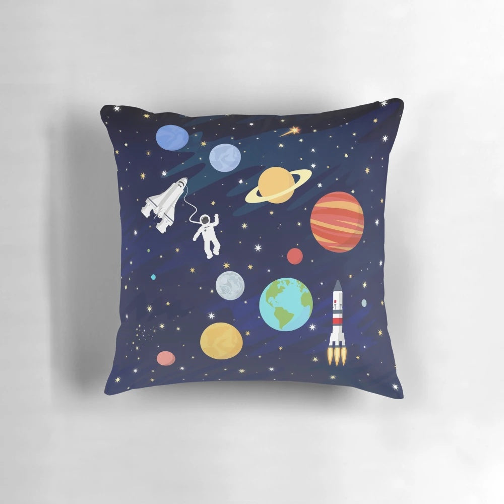 A colorful and whimsical space-themed pillow with illustrations of rockets, stars, planets, and the cosmos.