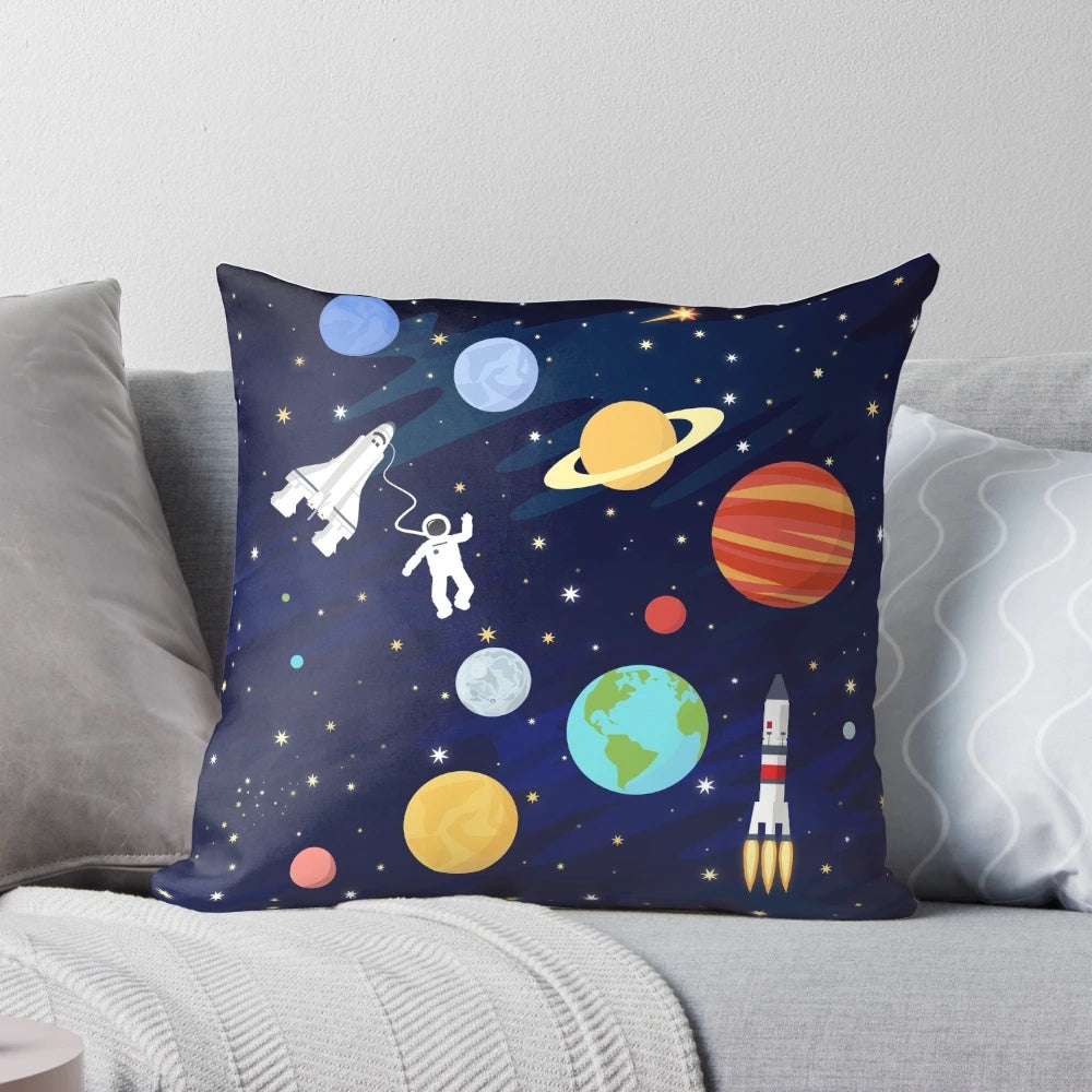 A colorful and whimsical space-themed pillow with illustrations of rockets, stars, planets, and the cosmos.