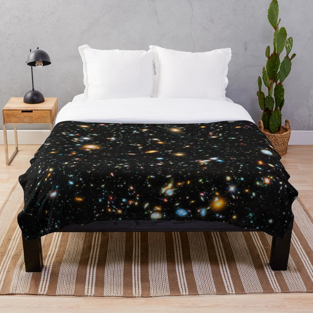 Hubble deep field inspired plush blanket with star field and galaxy design