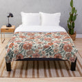 Soft and inviting plush blanket featuring a 70s inspired floral pattern in muted, earthy tones