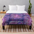 A cozy plush blanket featuring characters and imagery from the 80s fantasy film The Dark Crystal.