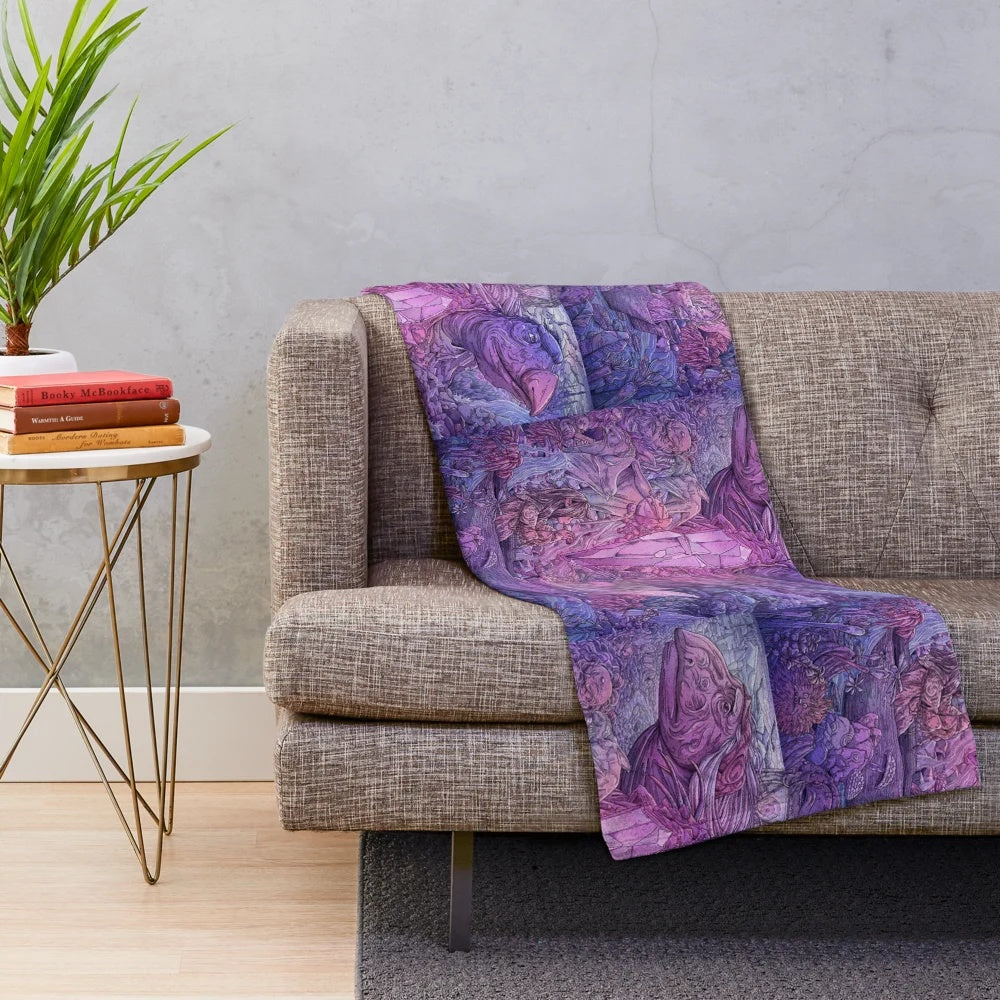 A cozy plush blanket featuring characters and imagery from the 80s fantasy film The Dark Crystal.